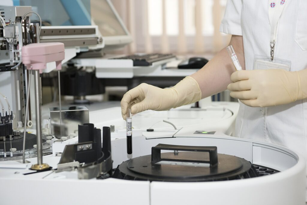 Scientist putting lab samples in centrifuge