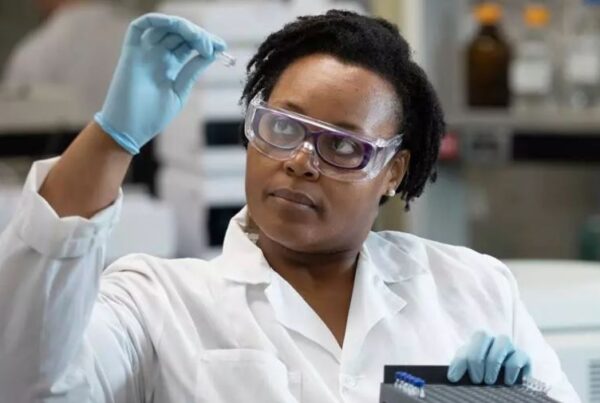 Scientist in a Lab Coat looking at Laboratory samples